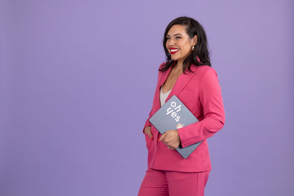 Kathy Dixon, founder and CEO of Oh Yes Communications, holding the 'oh yes' laptop